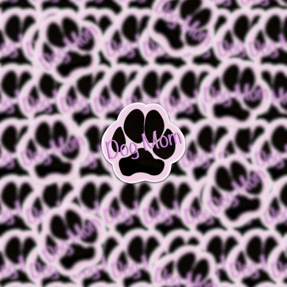 A decorative sticker featuring a background filled with black and pink paw prints adds charm, while a central large paw print displays "Dog Mom" in purple, making it an ideal Dog Mom Purple Sticker for any proud pet parent.