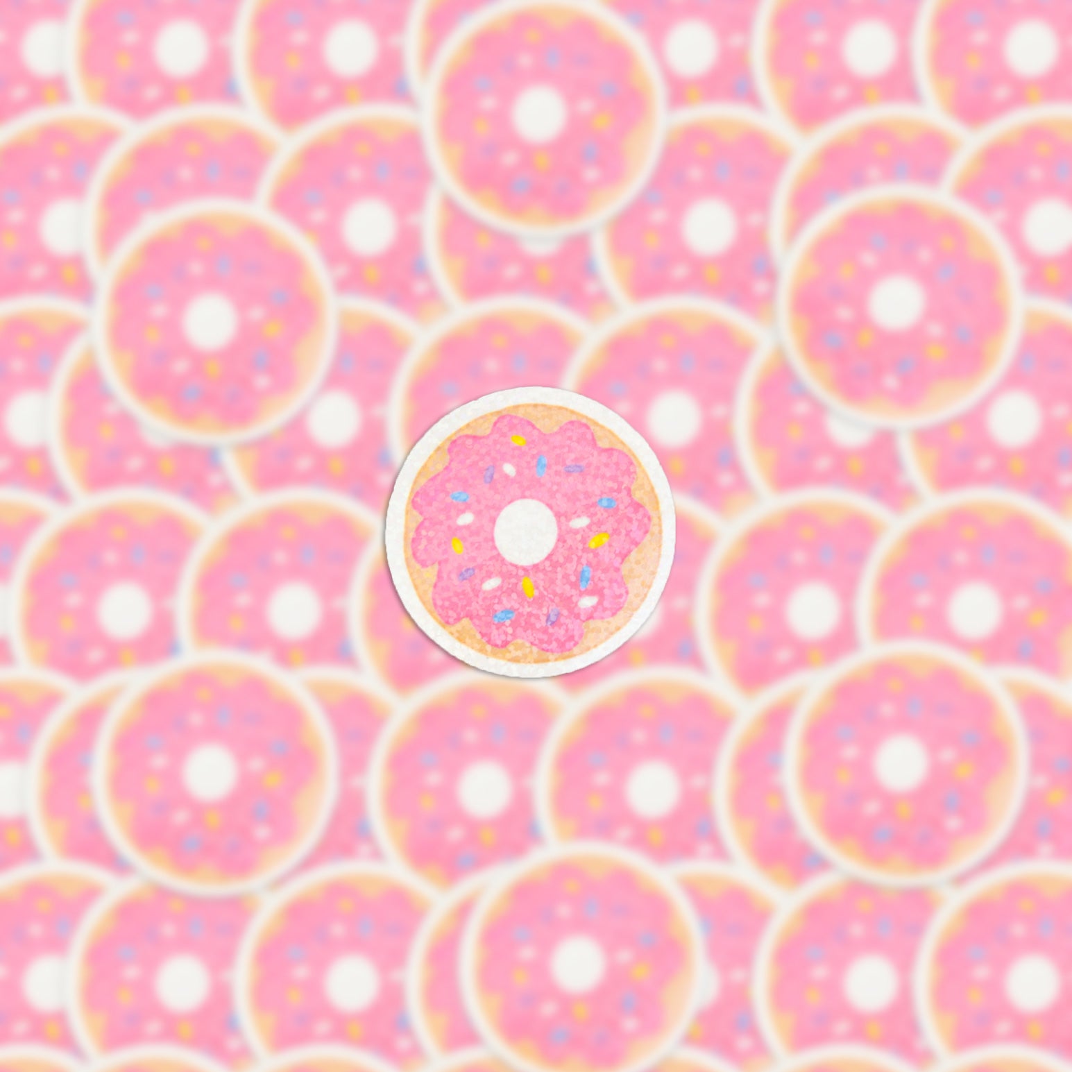 The image is filled with pink frosted donuts adorned with sprinkles, and the central donut is accentuated by a white outline, closely resembling the Strawberry Donut Holographic Sticker, thereby making it distinct among the surrounding treats.